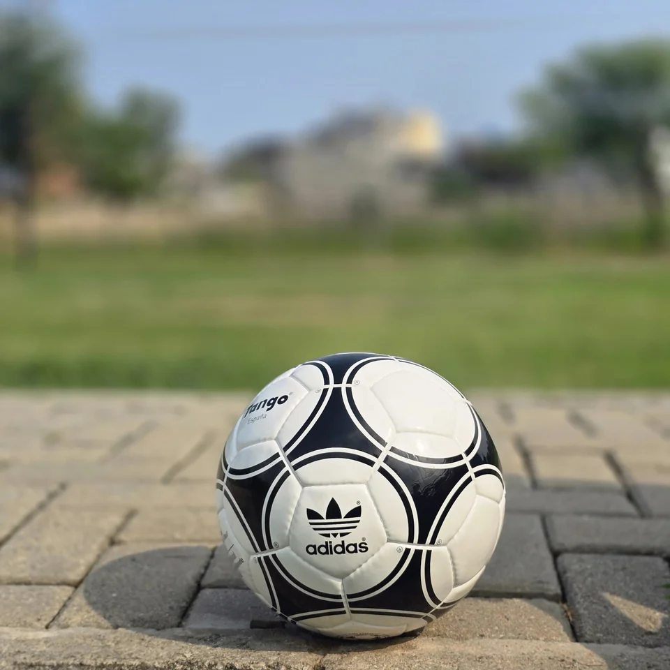 Black Circular Panel Hand-Stitched Football back view - white handmade football with black circular panel graphics and small printed details