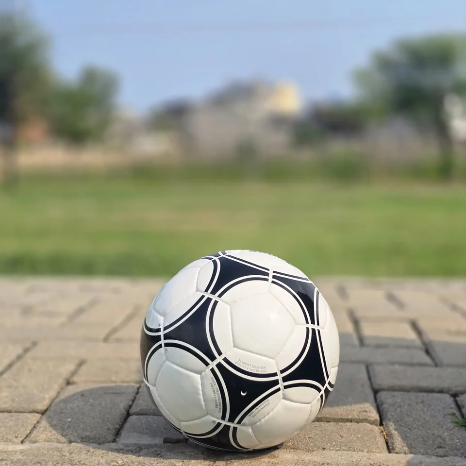 Black Circular Panel Hand-Stitched Football side view - white handmade football with black circular panel graphics and small printed details