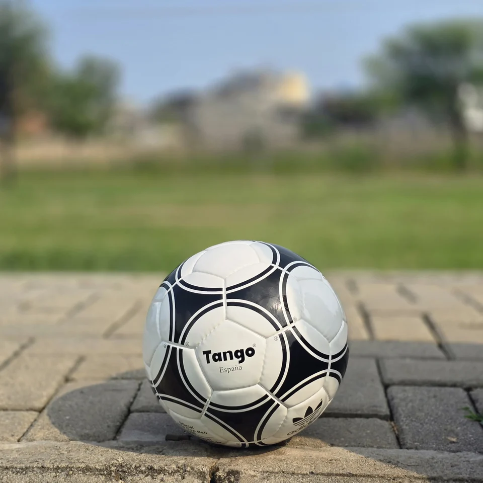 Black Circular Panel Hand-Stitched Football side view - white handmade football with black circular panel graphics and small printed details