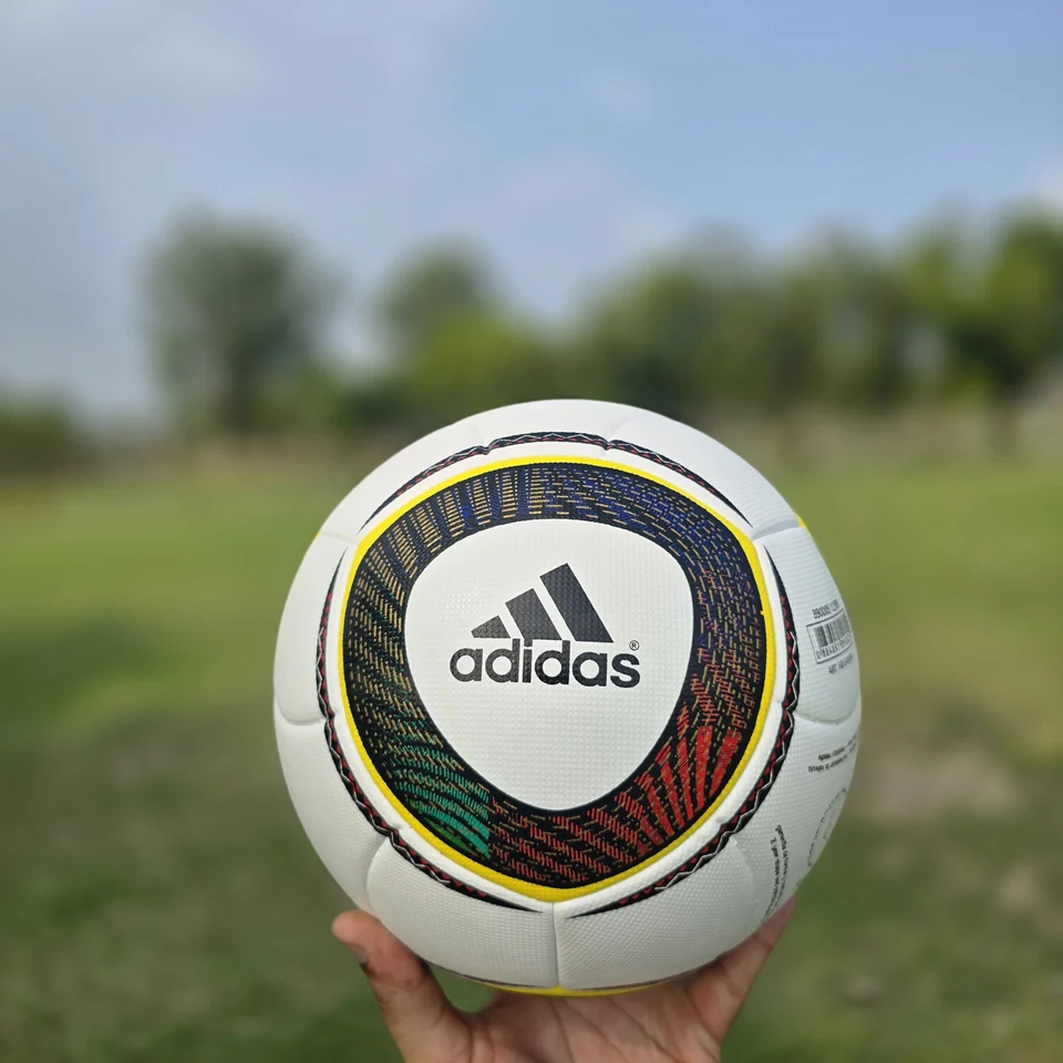 Black Gold Circular Panel Thermal Bonded Football back view - white thermal bonded football with black, gold, green, and red circular panel artwork