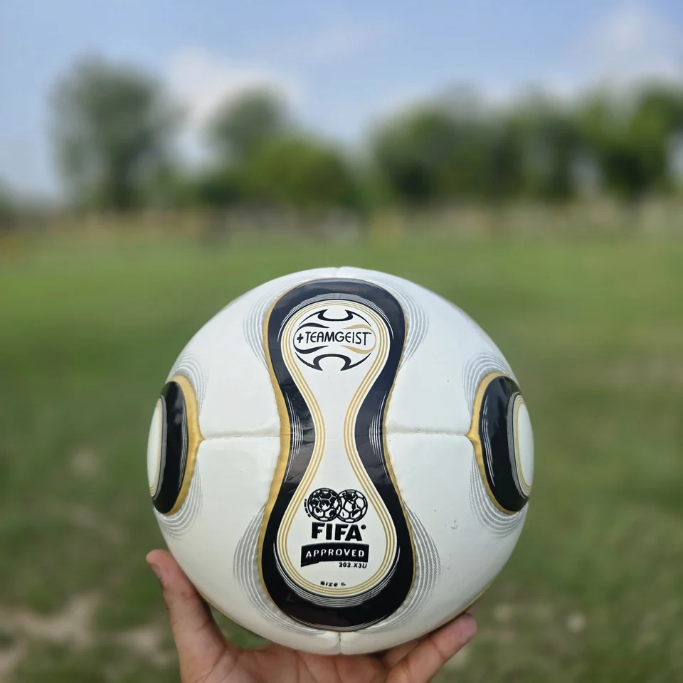 Black Gold Wave Hand-Stitched Football front view - white handmade football with black and gold wave-shaped panel graphics