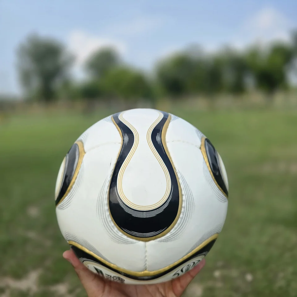 Black Gold Wave Hand-Stitched Football side view - white handmade football with black and gold wave-shaped panel graphics