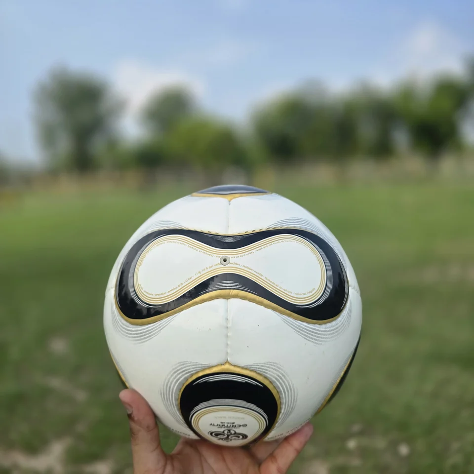 Black Gold Wave Hand-Stitched Football side view - white handmade football with black and gold wave-shaped panel graphics