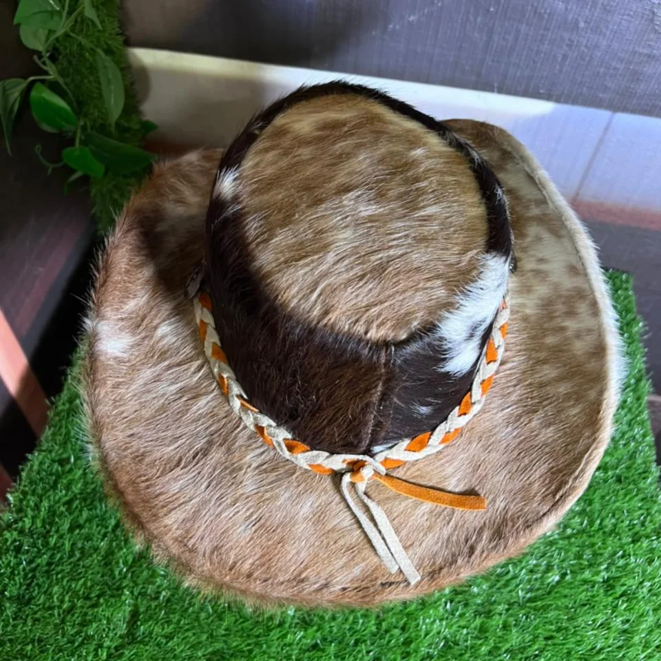 Cowhide Western Hat with Orange Cream Braided Band side view - brown, black, and cream cowhide western hat with orange and cream braided band