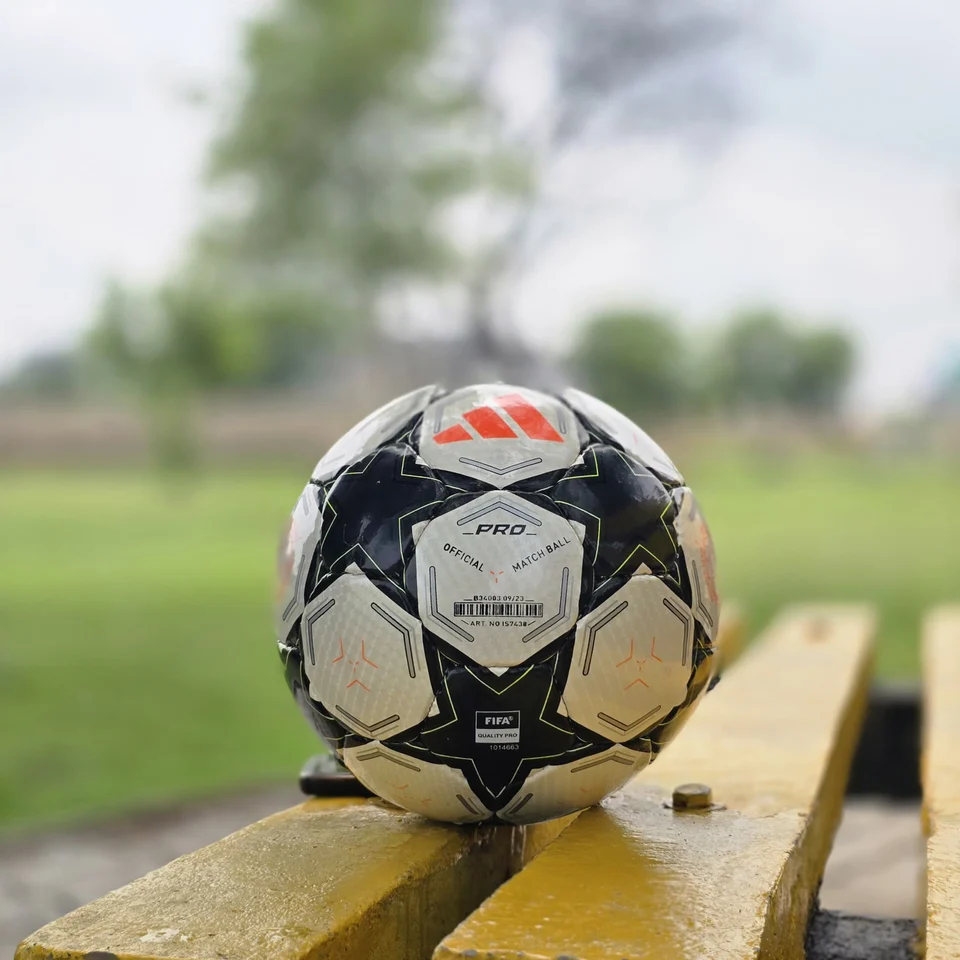 Black Star Graphic Hand-Stitched Football alternate front angle - black and white handmade football with star-shaped panels and a small green centre detail