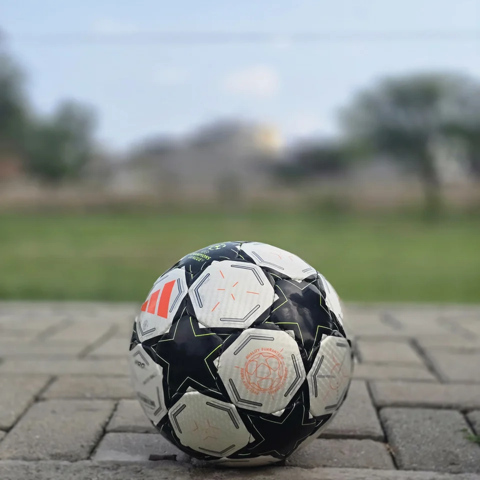 Black Star Panel Hand-Stitched Football alternate front angle - white and black handmade football with bold star-shaped panel artwork and a small red accent