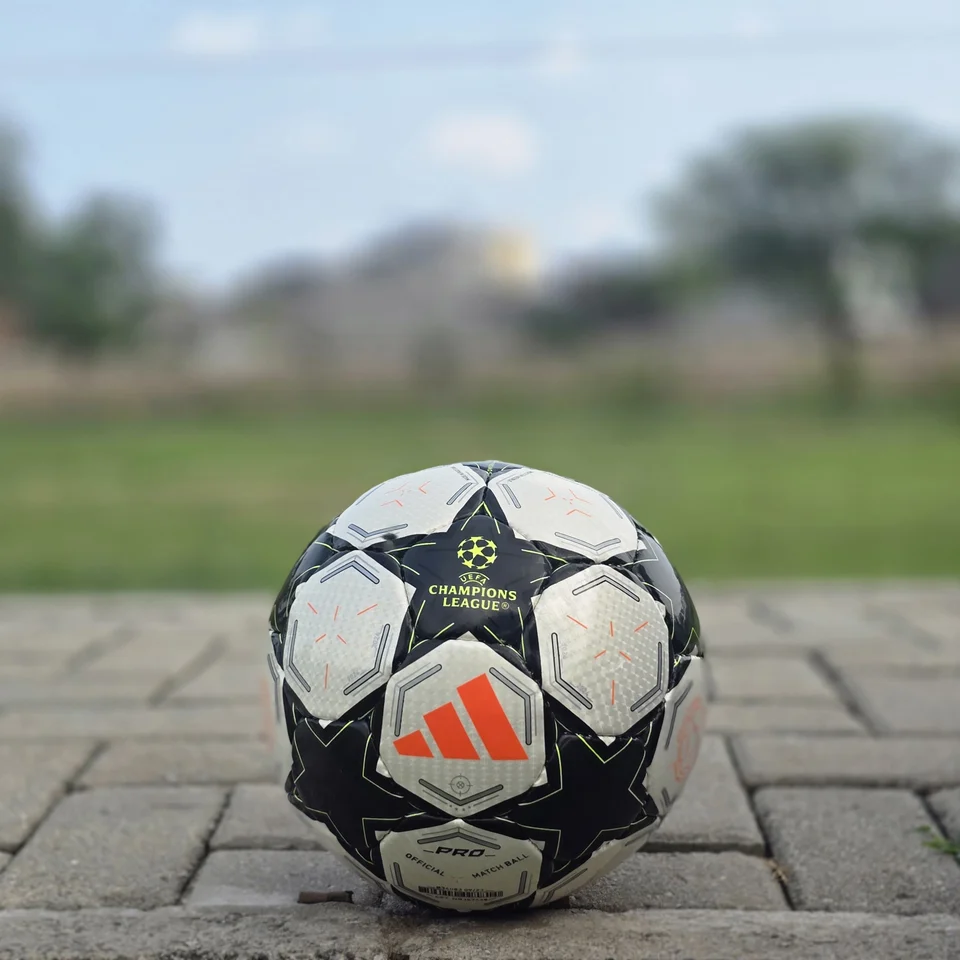 Black Star Panel Hand-Stitched Football back view - white and black handmade football with bold star-shaped panel artwork and a small red accent