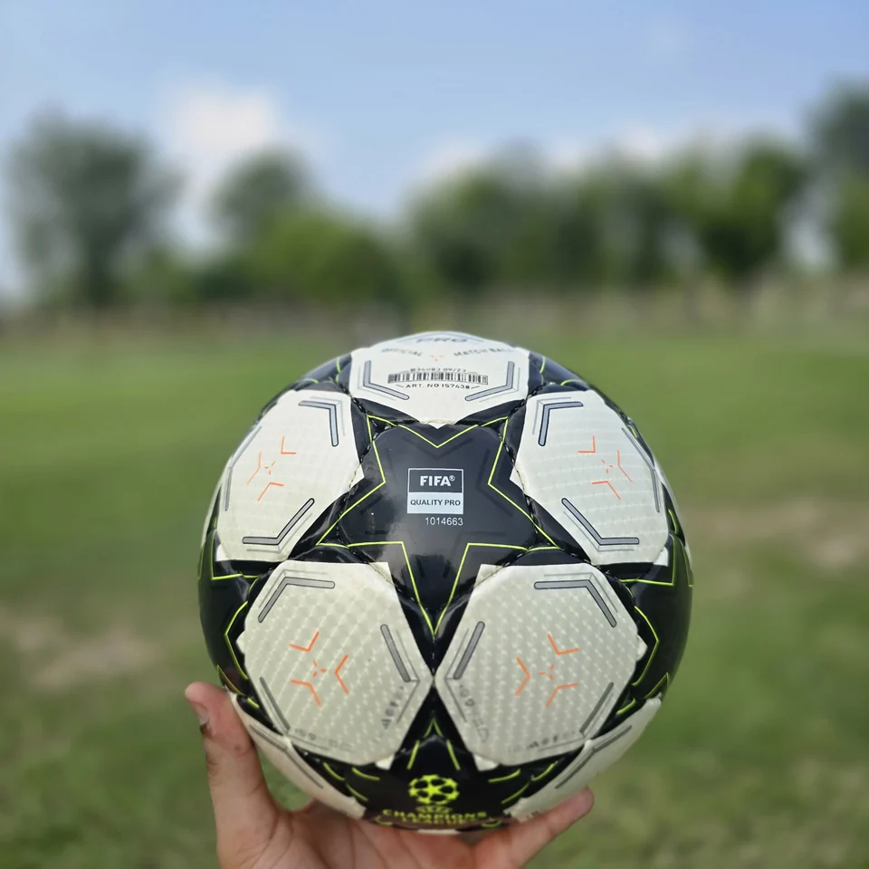 Black White Green Star Hand-Stitched Football alternate front angle - black and white handmade football with star panels and a green centre graphic
