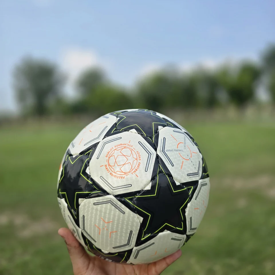 Black White Green Star Hand-Stitched Football side view - black and white handmade football with star panels and a green centre graphic