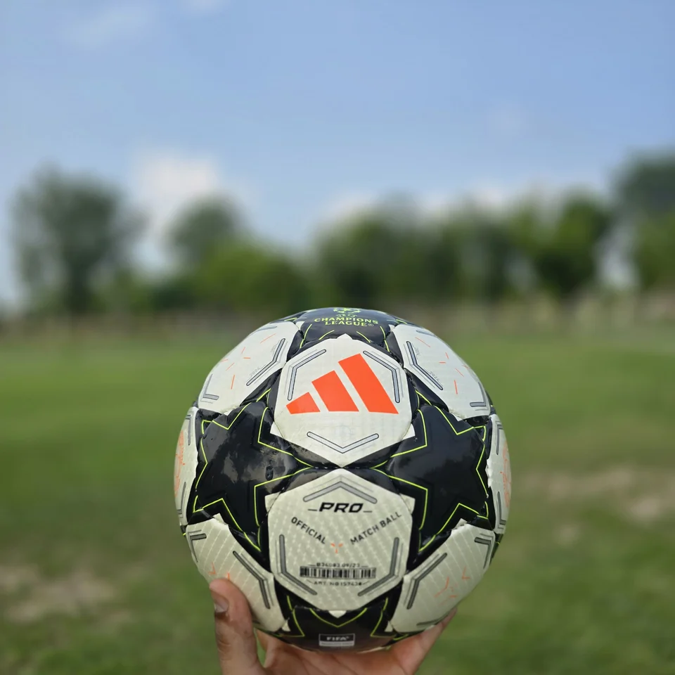 Black White Green Star Hand-Stitched Football side view - black and white handmade football with star panels and a green centre graphic