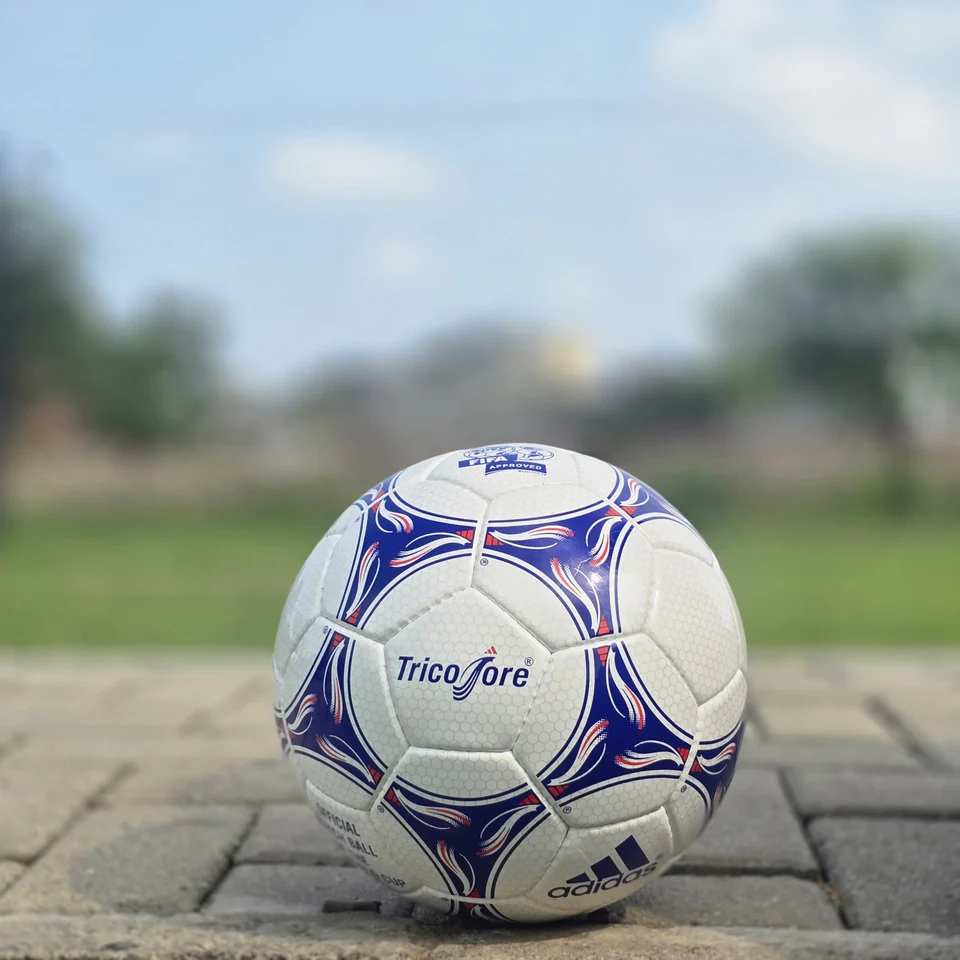 Blue & Purple Panel Hand-Stitched Football design detail - white handmade football with blue and purple flowing panel graphics