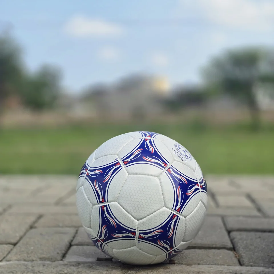 Blue & Purple Panel Hand-Stitched Football front view - white handmade football with blue and purple flowing panel graphics