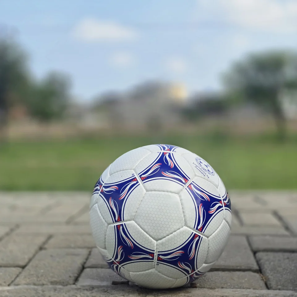 Blue & Purple Panel Hand-Stitched Football side view - white handmade football with blue and purple flowing panel graphics