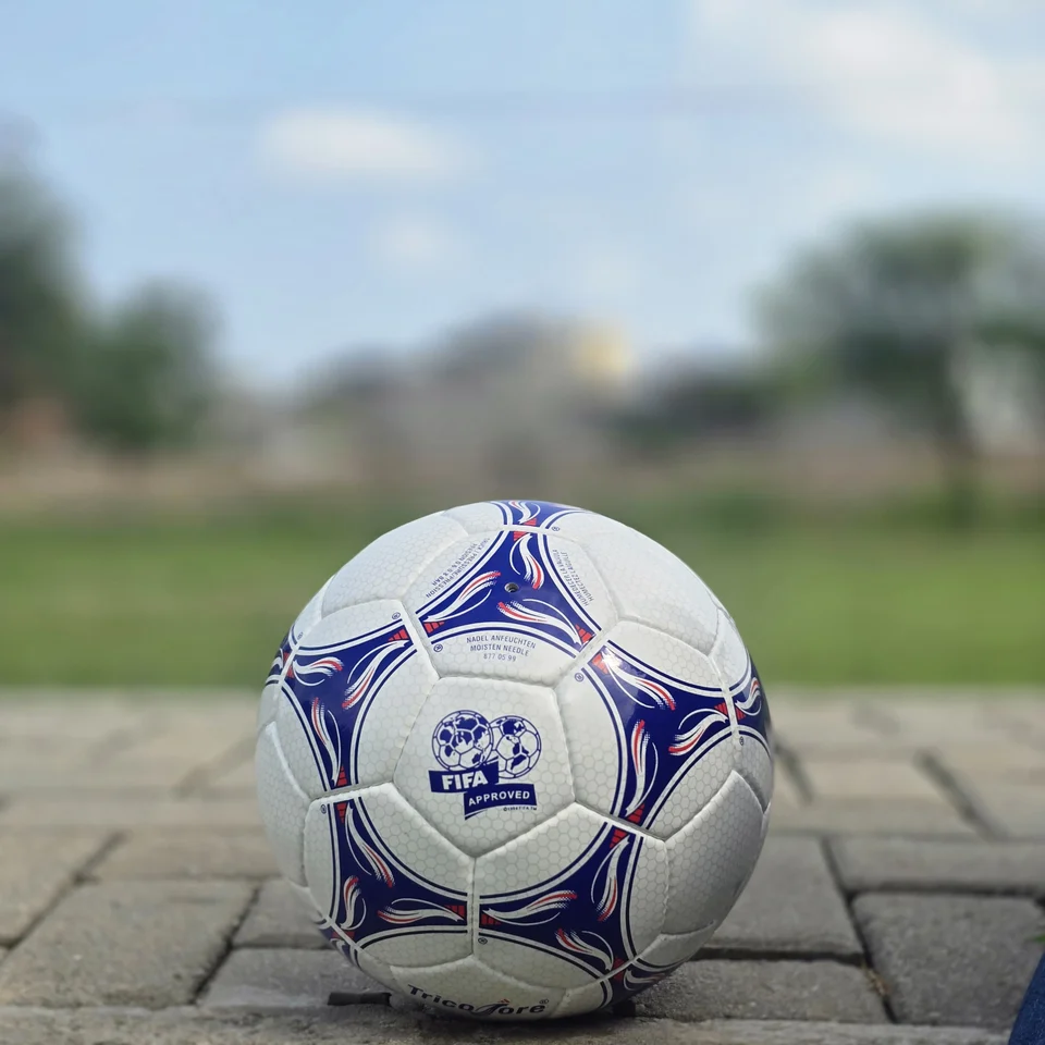 Blue & Purple Panel Hand-Stitched Football side view - white handmade football with blue and purple flowing panel graphics