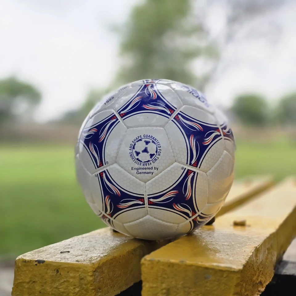 Blue Purple Training Hand-Stitched Football front view - white handmade football with blue and purple stitched graphic panels