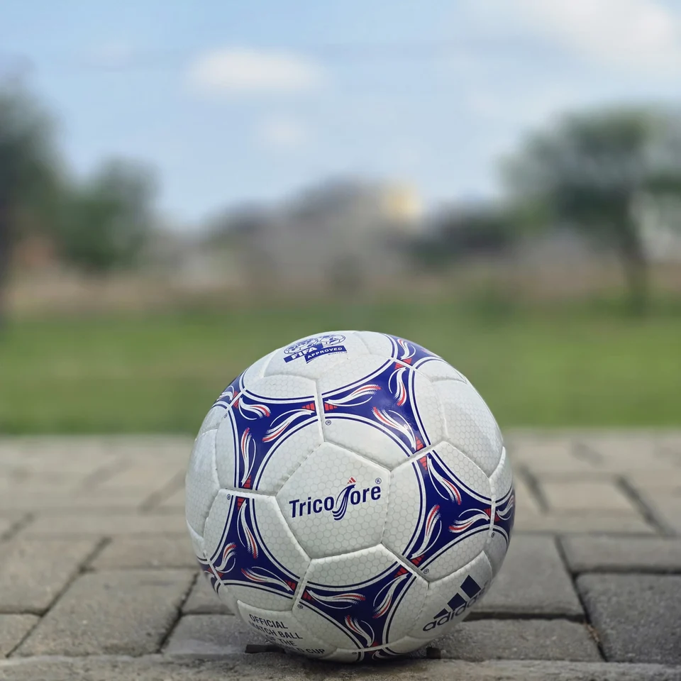 Blue Purple Tricolor-Style Hand-Stitched Football front view - white handmade football with blue and purple panel graphics and visible tricolor-style printed text