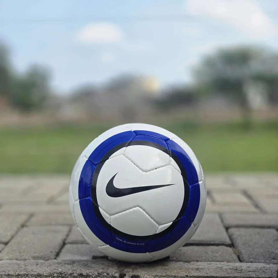 Blue Purple Tricolor-Style Hand-Stitched Football supporting view - white handmade football with blue and purple panel graphics and visible tricolor-style printed text