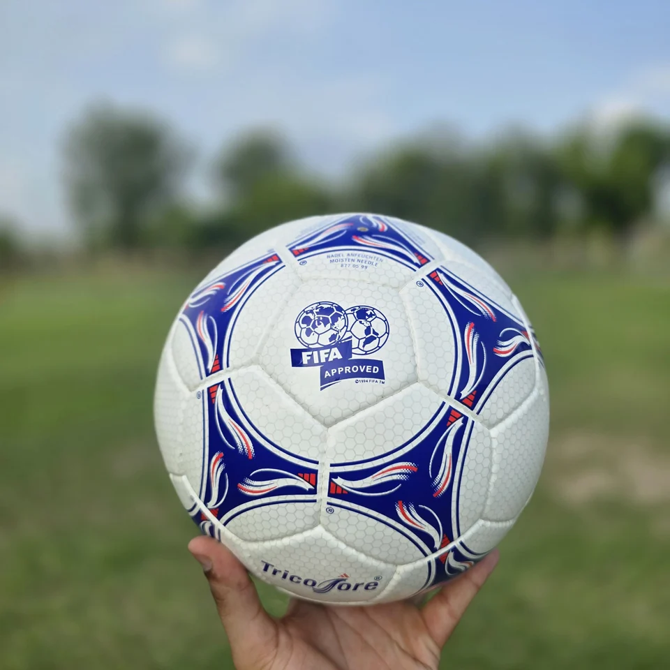 Blue Purple Wave Hand-Stitched Football side view - white handmade football with blue and purple wave-like stitched panel graphics