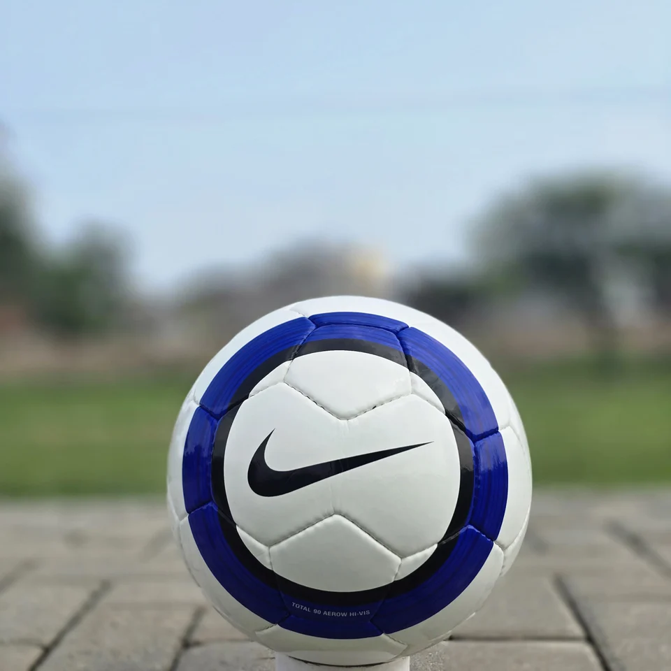 Blue Stripe Custom Panel Hand-Stitched Football back view - white handmade football with blue vertical stripes and a small printed badge detail