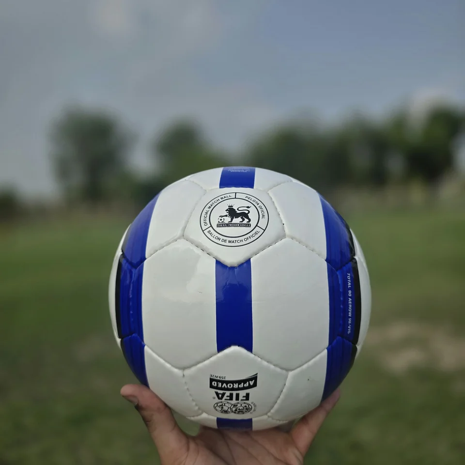 Blue Stripe GEO Style Hand-Stitched Football alternate front angle - white handmade football with blue vertical stripes and visible GEO-style printed panel text