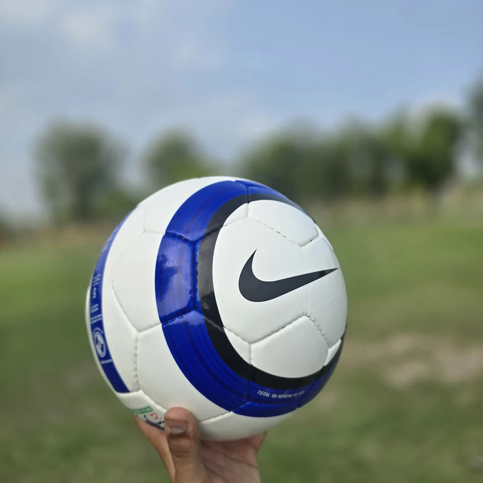 Blue Stripe GEO Style Hand-Stitched Football back view - white handmade football with blue vertical stripes and visible GEO-style printed panel text