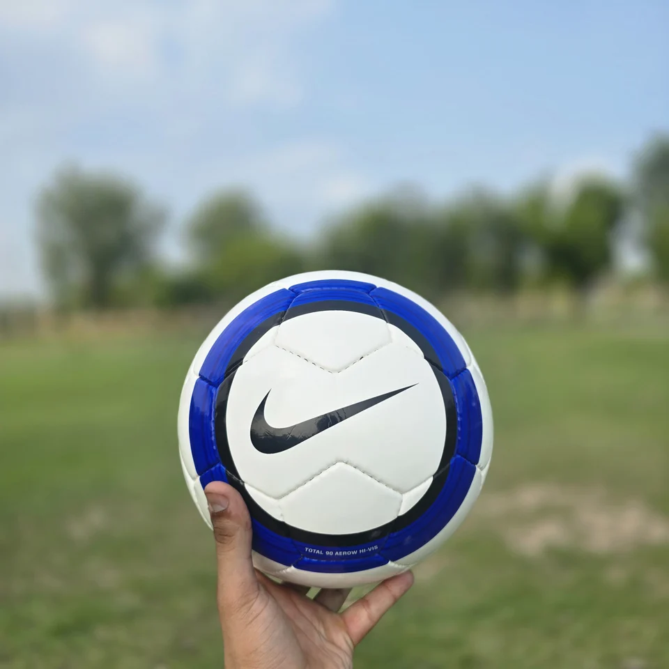 Blue Stripe GEO Style Hand-Stitched Football design detail - white handmade football with blue vertical stripes and visible GEO-style printed panel text