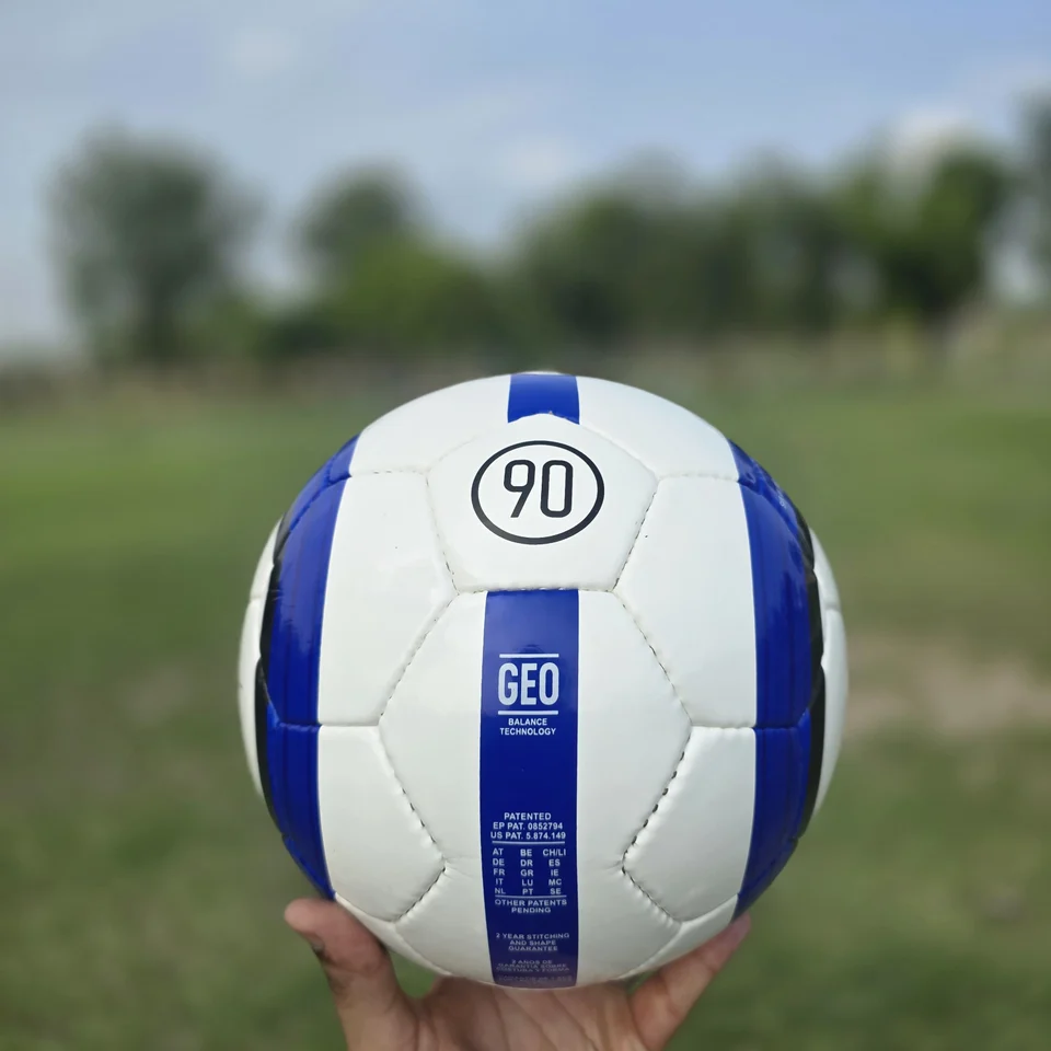 Blue Stripe GEO Style Hand-Stitched Football side view - white handmade football with blue vertical stripes and visible GEO-style printed panel text