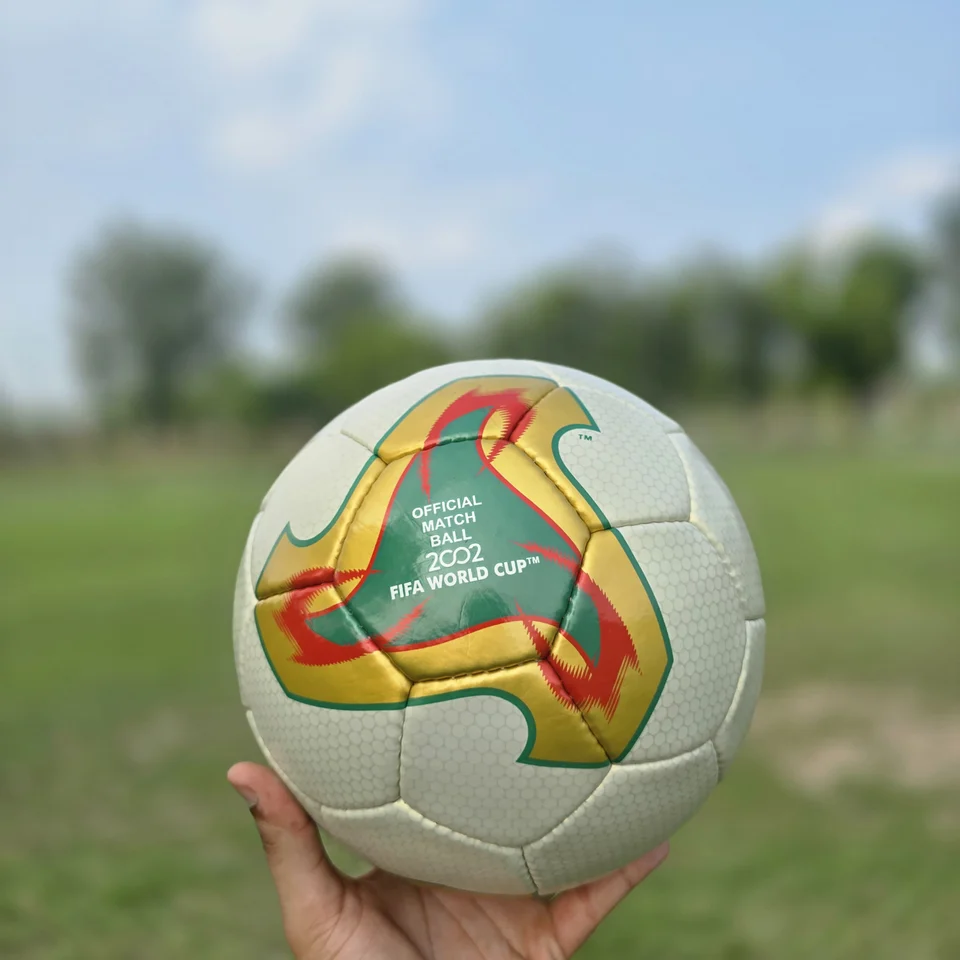 Cream Orange Geometric Hand-Stitched Football alternate front angle - cream handmade football with orange, tan, and green geometric graphics