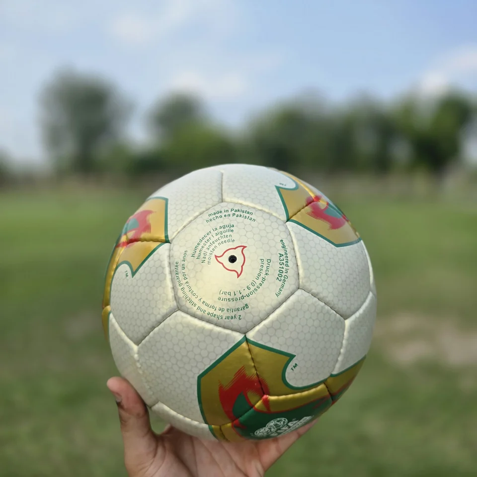 Cream Orange Geometric Hand-Stitched Football back view - cream handmade football with orange, tan, and green geometric graphics