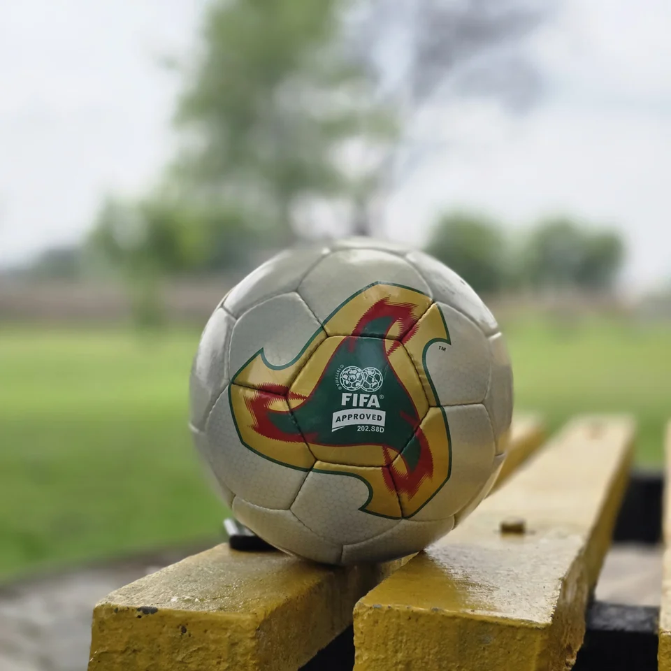 Cream Tan Graphic Hand-Stitched Football alternate front angle - cream handmade football with tan, orange, and green printed geometric panel accents