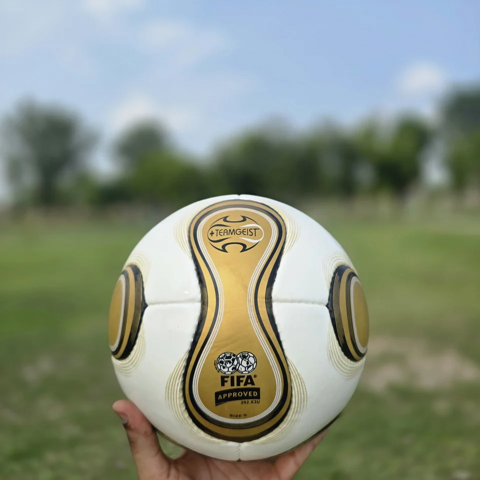 Gold Swirl Hand-Stitched Football alternate front angle - white handmade football with gold and black swirl panel artwork