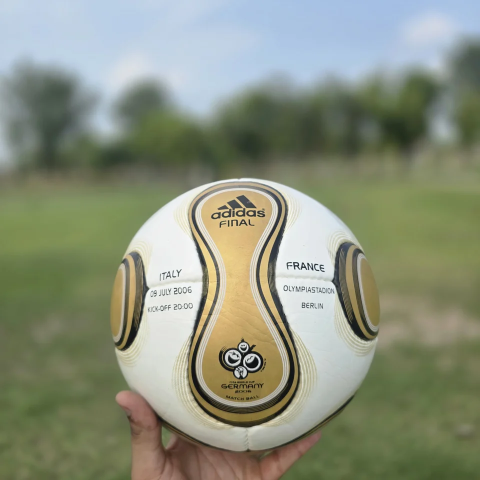 Gold Swirl Hand-Stitched Football side view - white handmade football with gold and black swirl panel artwork