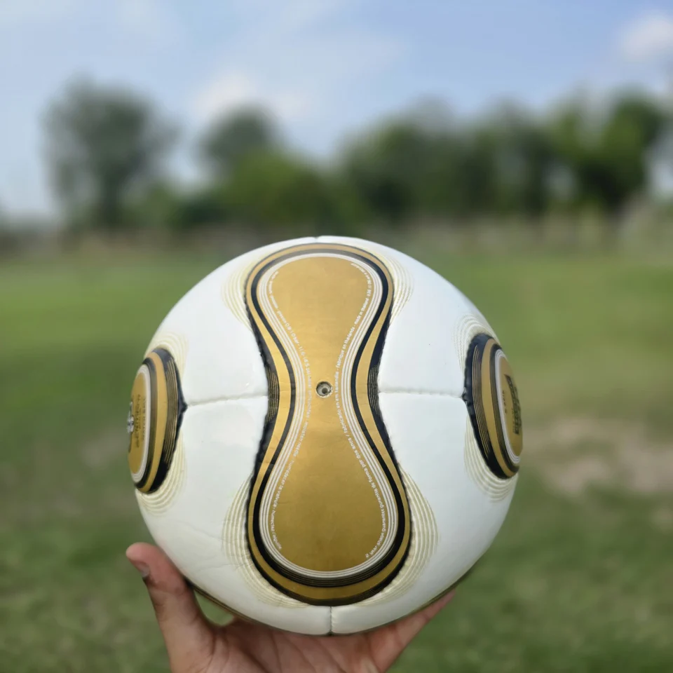 Gold Swirl Hand-Stitched Football side view - white handmade football with gold and black swirl panel artwork