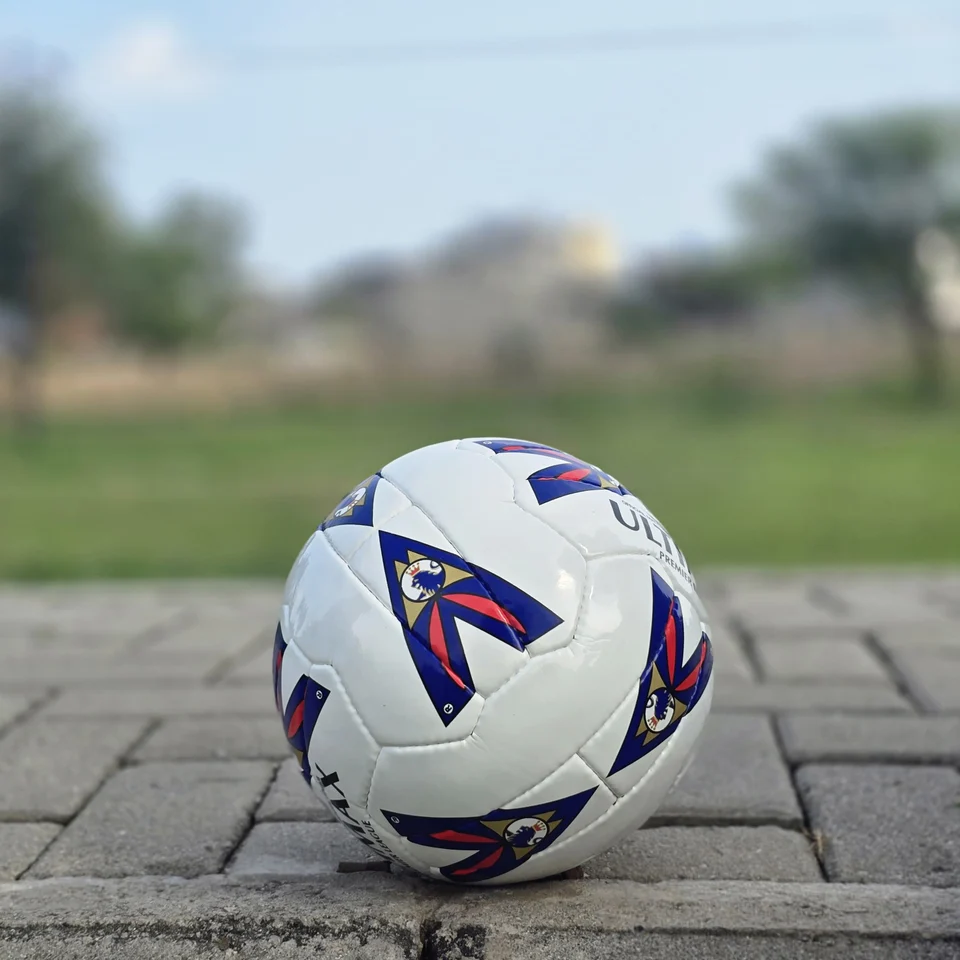 Red & Blue Arrow Panel Hand-Stitched Football alternate front angle - white handmade football with red and blue arrow-style panel graphics