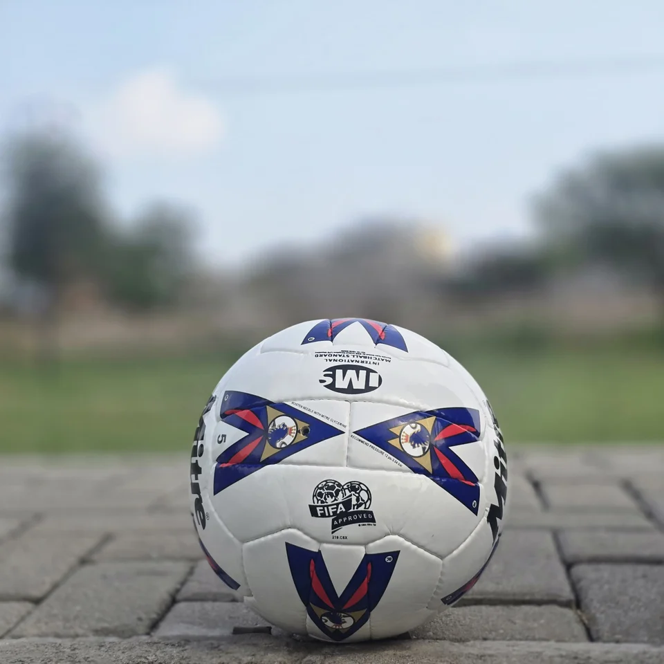 Red & Blue Arrow Panel Hand-Stitched Football back view - white handmade football with red and blue arrow-style panel graphics
