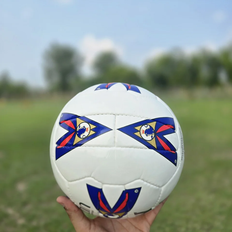 Red Blue Arrow Graphic Hand-Stitched Football front view - white handmade football with red and blue arrow-shaped graphic panels