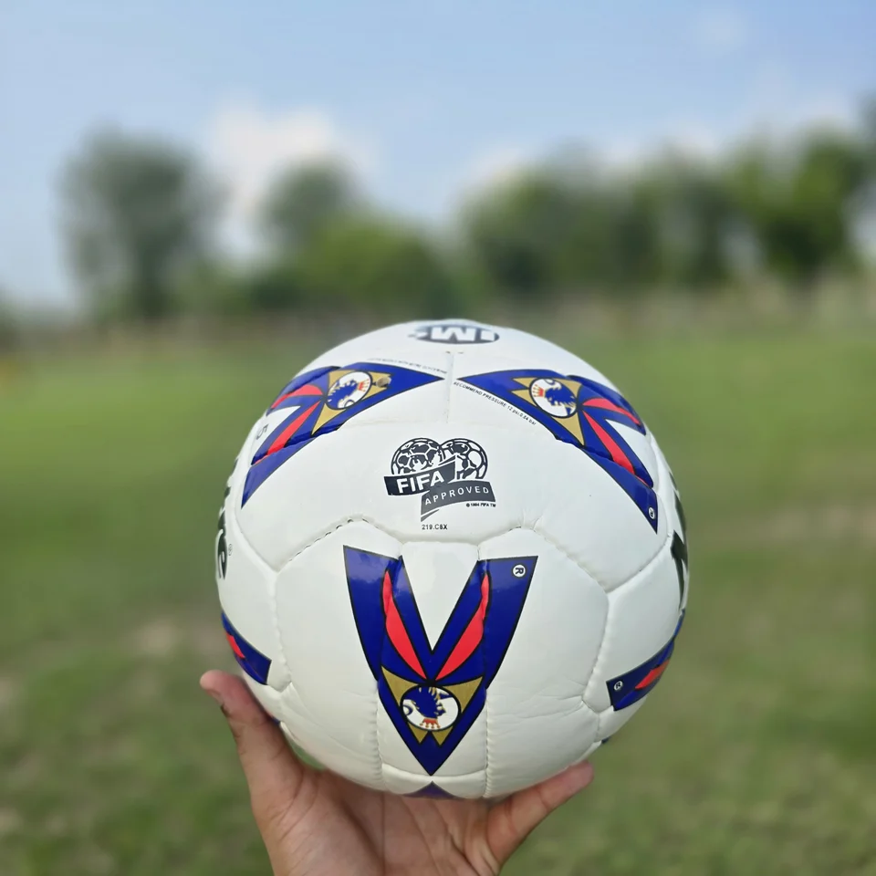 Red Blue Arrow Graphic Hand-Stitched Football side view - white handmade football with red and blue arrow-shaped graphic panels
