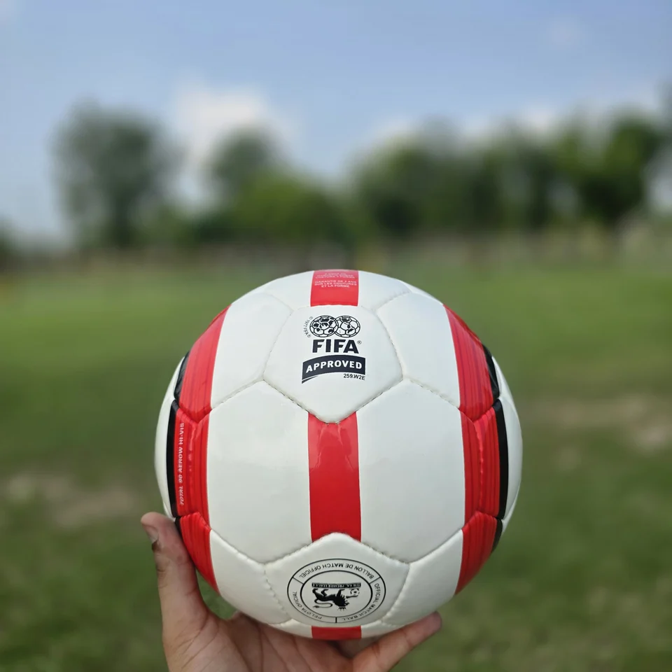 Red Vertical Stripe Hand-Stitched Football design detail - white handmade football with red vertical stripe panels and printed badge detail