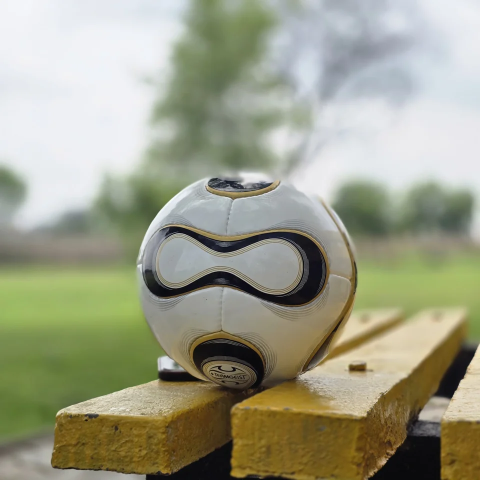 White Black Gold Swirl Hand-Stitched Football side view - white handmade football with black and gold swirl panel artwork