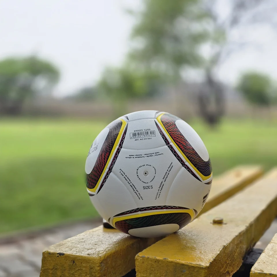 White Black Yellow Accent Hand-Stitched Football back view - white handmade football with black, yellow, green, and red accent panel graphics