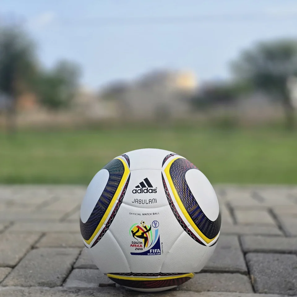 White Black Yellow Ring Thermal Bonded Football front view - white thermal bonded football with black and yellow circular ring panel graphics