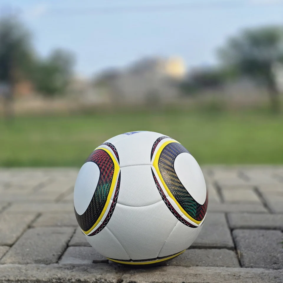 White Black Yellow Ring Thermal Bonded Football side view - white thermal bonded football with black and yellow circular ring panel graphics