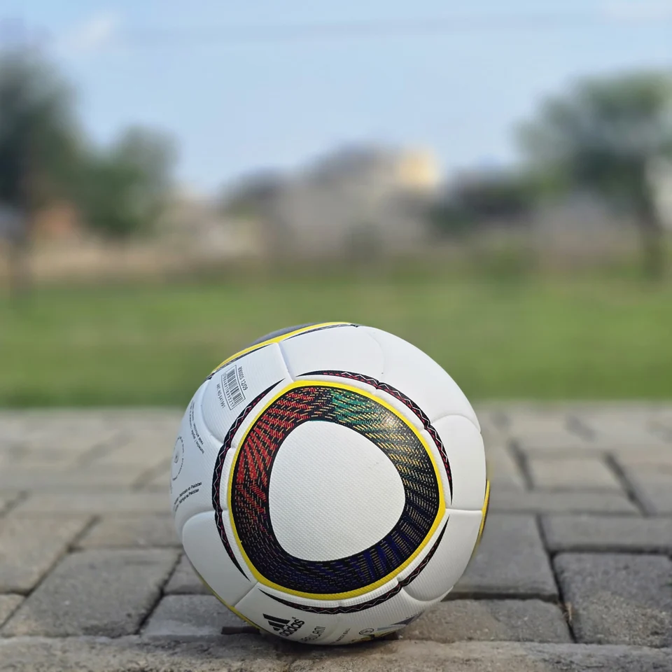 White Black Yellow Ring Thermal Bonded Football side view - white thermal bonded football with black and yellow circular ring panel graphics