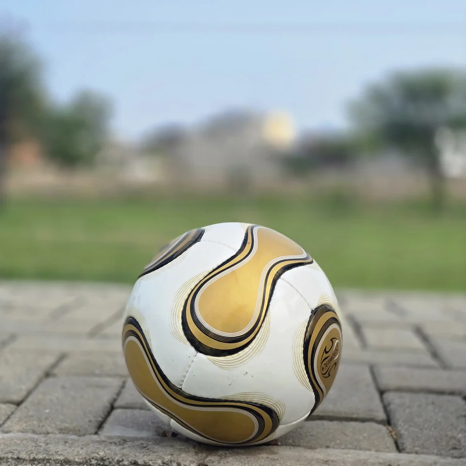 White Gold Swirl Hand-Stitched Football back view - white handmade football with metallic gold and black flowing swirl graphics