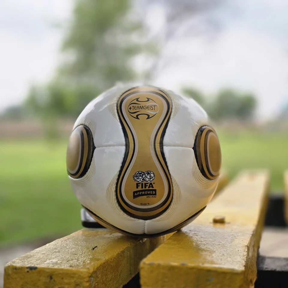 White Gold Wave Hand-Stitched Football side view - white handmade football with gold wave graphics and black trim