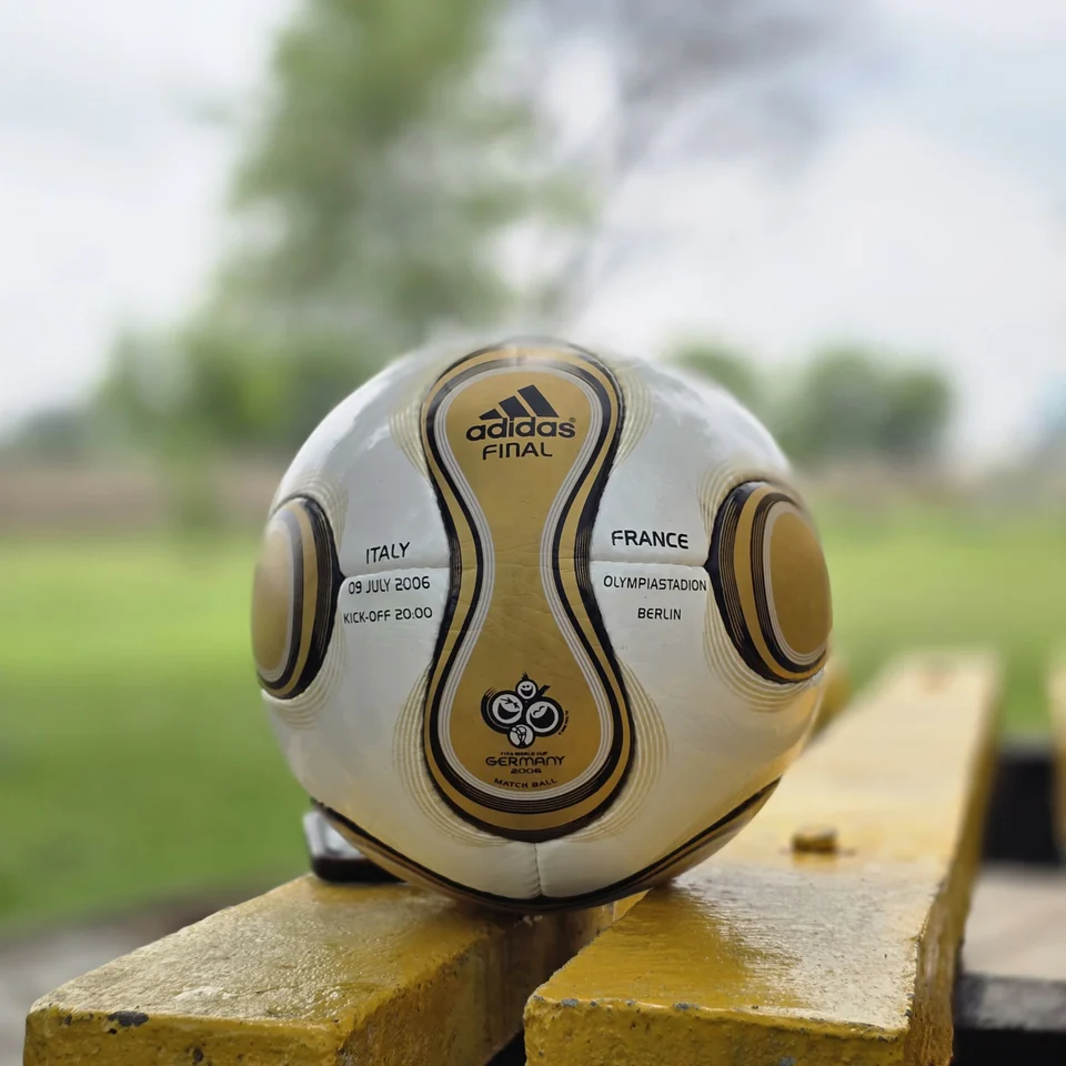 White Gold Wave Hand-Stitched Football side view - white handmade football with gold wave graphics and black trim