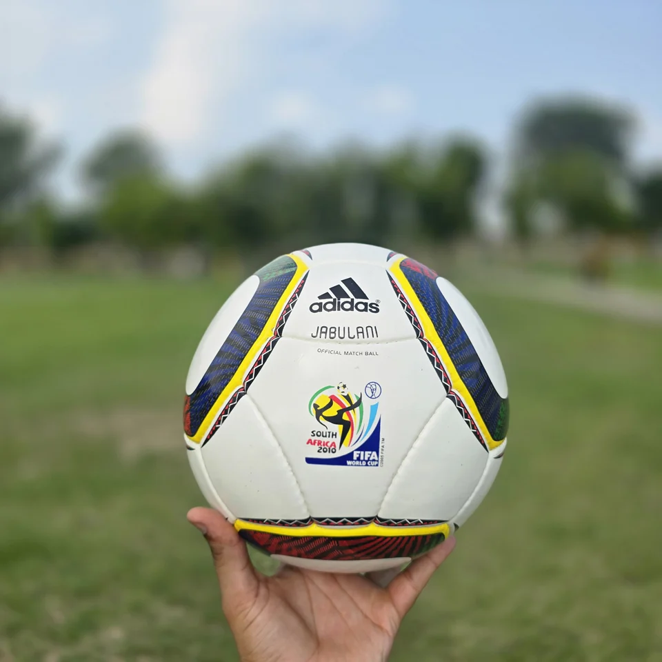 White Green Yellow Panel Hand-Stitched Football front view - white handmade football with green, yellow, and black panel accents