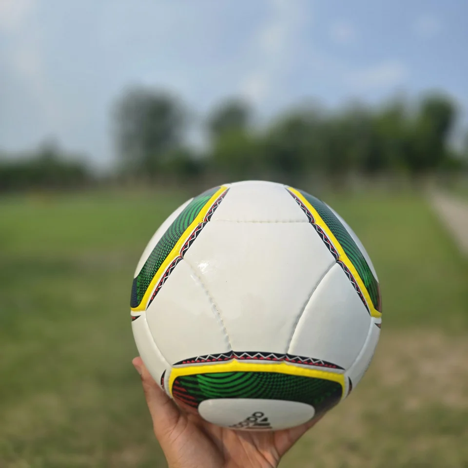 White Green Yellow Panel Hand-Stitched Football side view - white handmade football with green, yellow, and black panel accents
