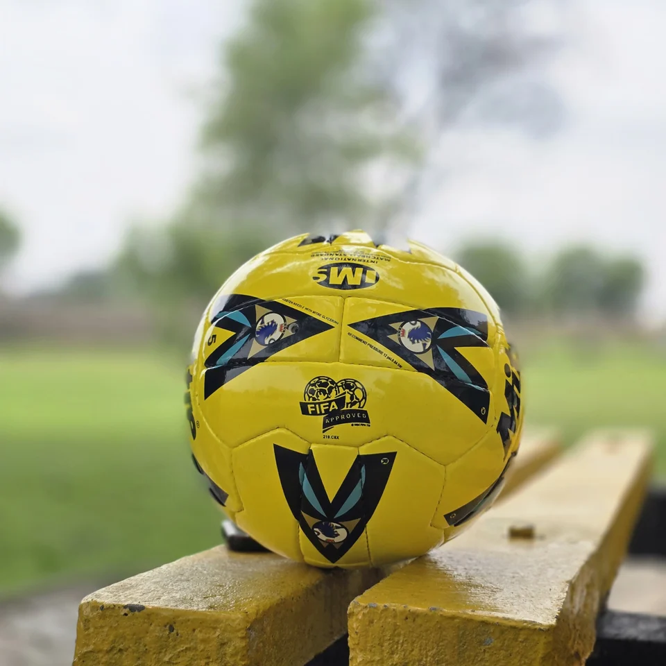 Yellow Black Crest Panel Hand-Stitched Football back view - yellow handmade football with black graphic panels and a small crest-style mark