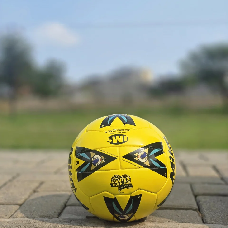 Yellow Black Graphic Hand-Stitched Football front view - bright yellow handmade football with black angular graphic panels
